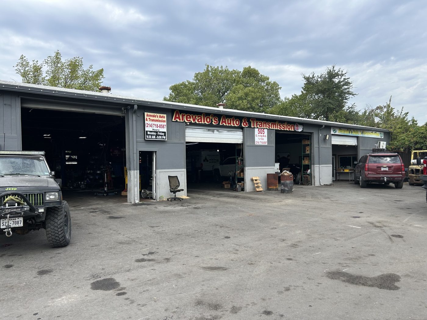 The Arevalo's Auto & Transmission shop front at 505 E Irving Blvd, Irving, Texas, with the bay doors open